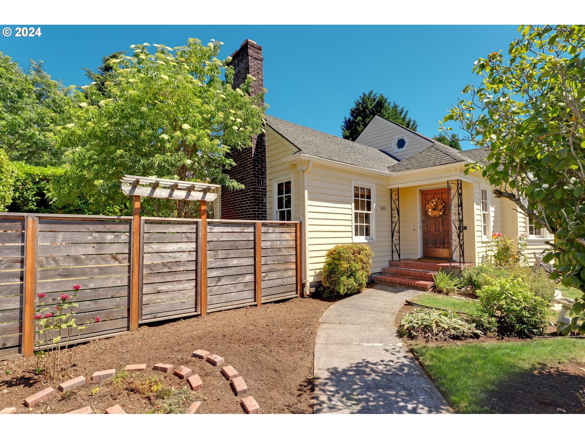 6003 Southeast Stephens Street Portland, OR 97215 - Photo 5 of 46 a view of a house with wooden fence
