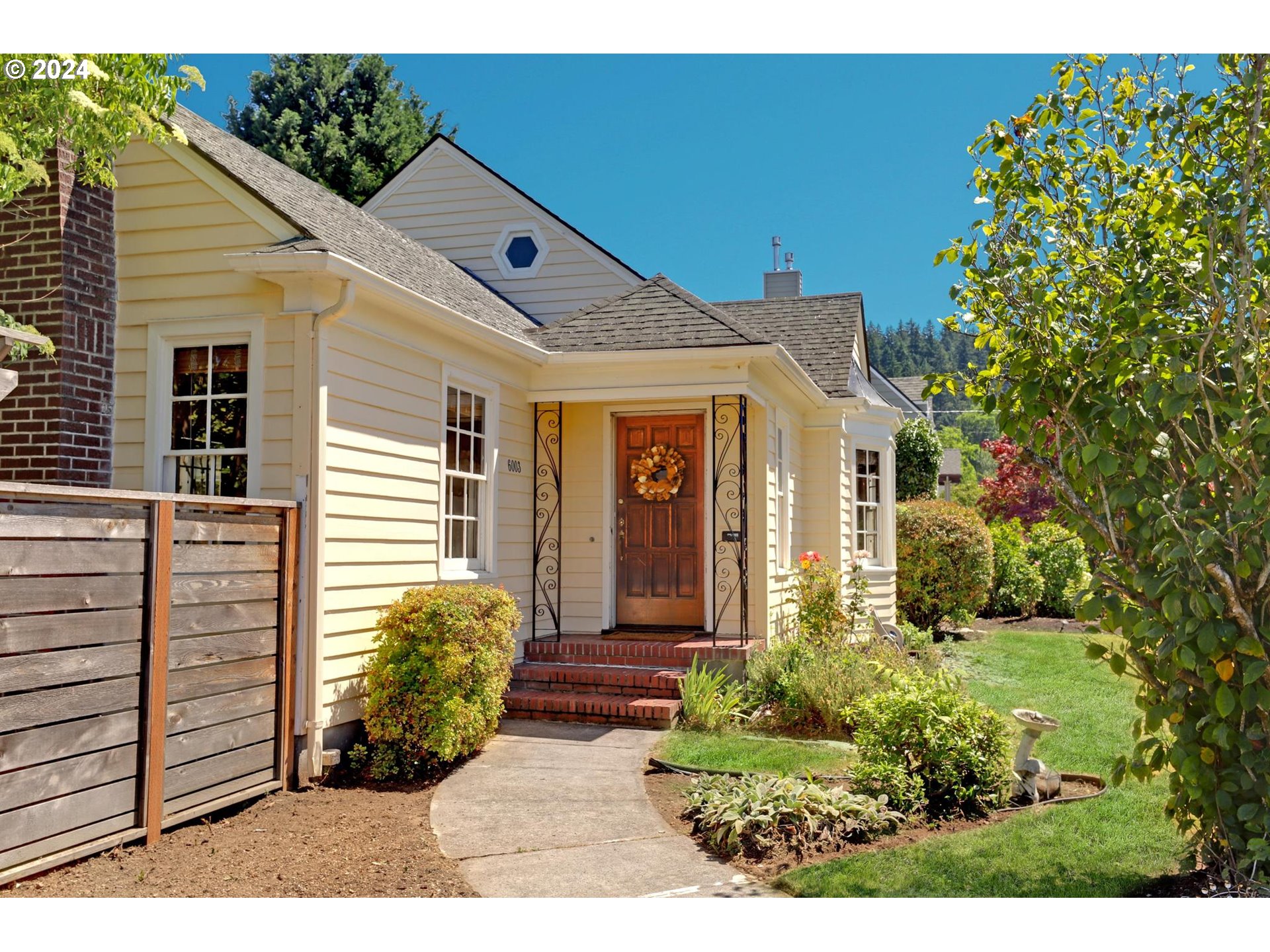 6003 Southeast Stephens Street Portland, OR 97215 - Photo 6 of 46 a front view of a house with garden