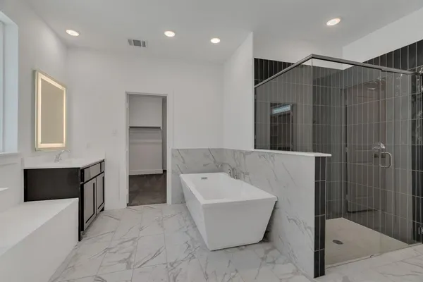 a bathroom with a bathtub and a shower