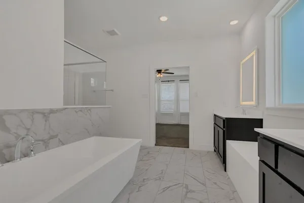 a bathroom with a bathtub and a sink