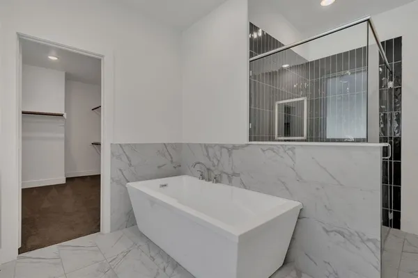 a bathroom with a bathtub and a shower