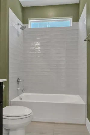 a bathroom with a toilet and a bathtub