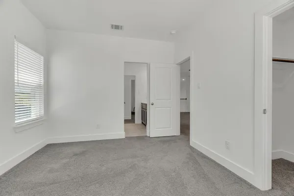 an empty room with a empty space and windows