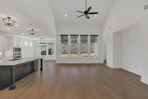 a view of a kitchen with a sink wooden floor and a window