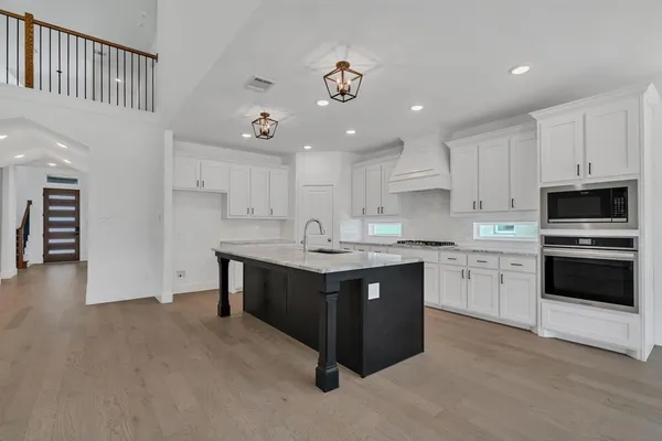 a kitchen with a sink cabinets and stainless steel appliances