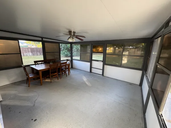 a view of a livingroom with furniture and a window