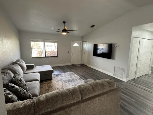 a living room with furniture and a flat screen tv