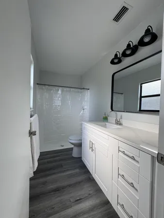 a bathroom with a double vanity sink and mirror