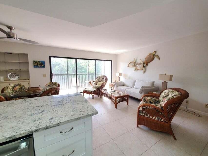 1605 Highway 1, Unit F203 Jupiter, FL 33477 - Photo 12 of 39 a living room with furniture and a large window