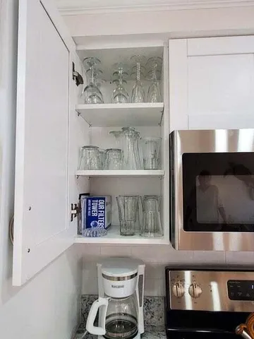 a kitchen with a sink and wooden floor