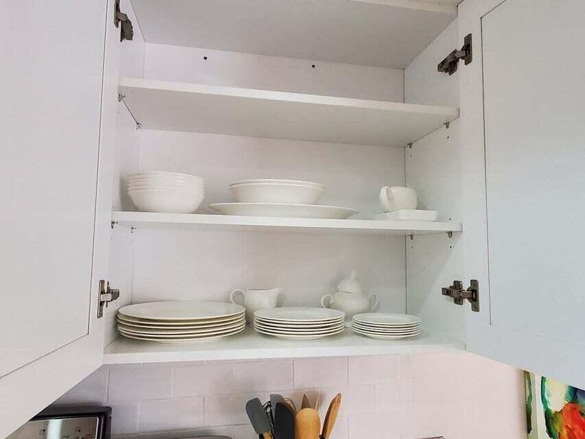1605 Highway 1, Unit F203 Jupiter, FL 33477 - Photo 18 of 39 a kitchen with a sink and wooden floor