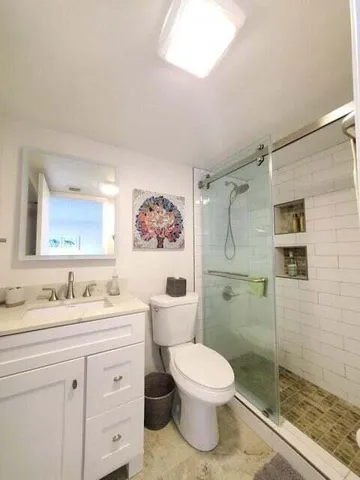 a bathroom with a toilet and a shower