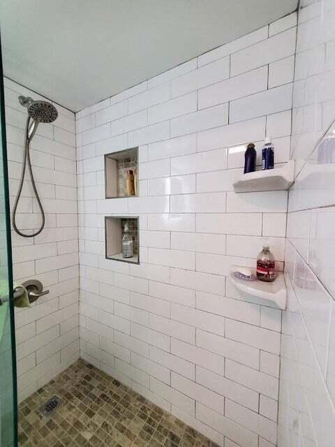1605 Highway 1, Unit F203 Jupiter, FL 33477 - Photo 31 of 39 a bathroom with a shower