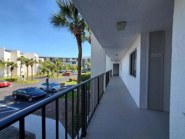 a view of balcony with wooden floor and bench