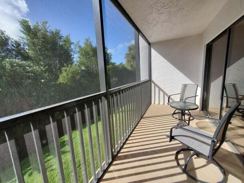 1605 Highway 1, Unit F203 Jupiter, FL 33477 - Photo 7 of 39 a view of balcony with wooden floor and bench