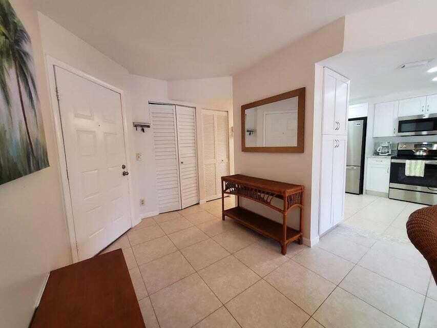 1605 Highway 1, Unit F203 Jupiter, FL 33477 - Photo 9 of 39 a spacious bedroom with a bed and a couch