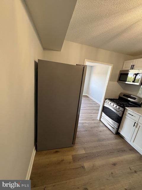 1836 Metzerott Road, Unit 704 Hyattsville, MD 20783 - Photo 27 of 33 a view of room with window and wooden floor