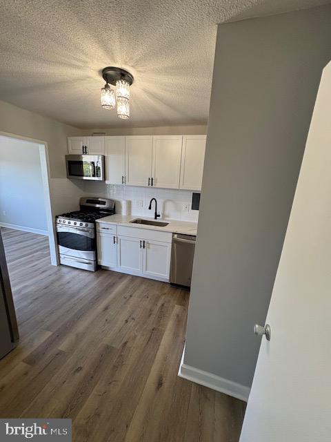 1836 Metzerott Road, Unit 704 Hyattsville, MD 20783 - Photo 3 of 33 a kitchen with a sink a refrigerator and chairs