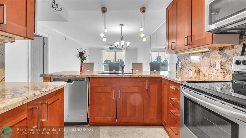 a kitchen with stainless steel appliances granite countertop a sink and cabinets