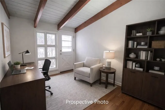 a living room with furniture and a book shelf