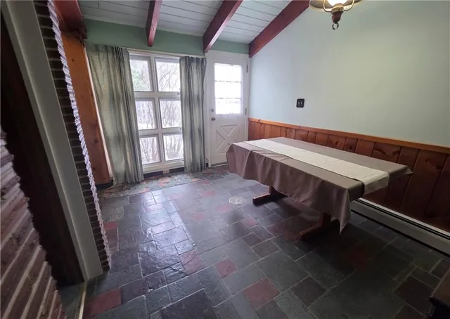 a room with pool table and windows
