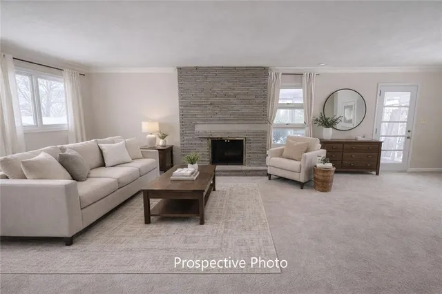 a living room with furniture a fireplace and a large window