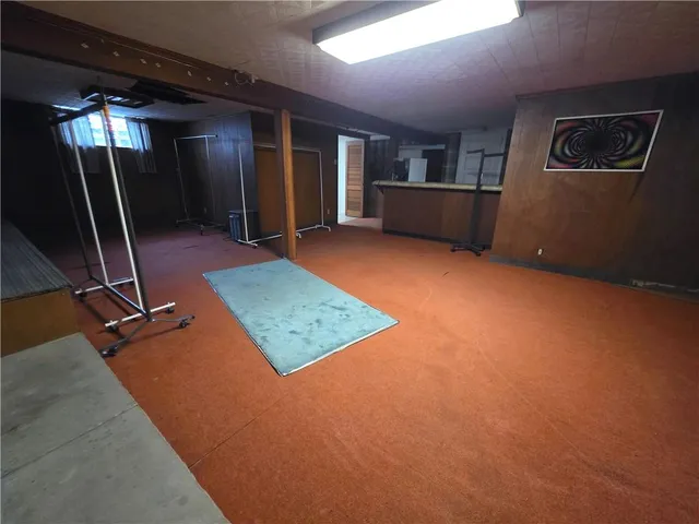 a view of an empty room with gym equipment
