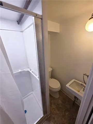 a white toilet sitting next to a bathroom sink