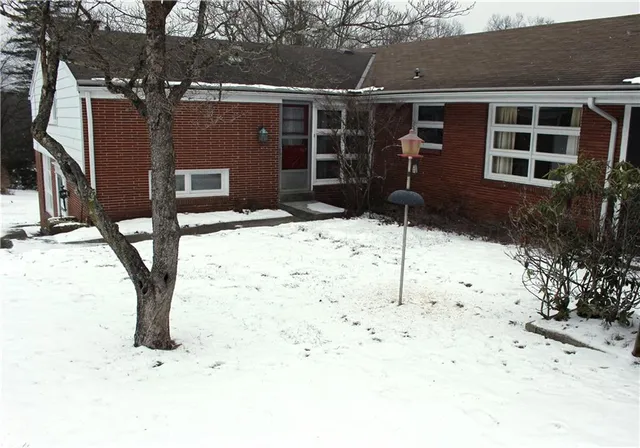 a backyard of a house with table and chairs