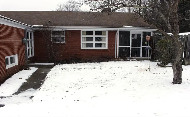 a view of house with snow on the road