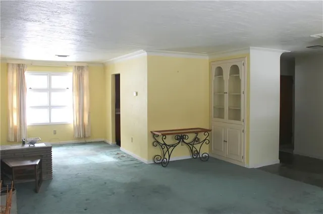 a view of a livingroom with furniture and a window