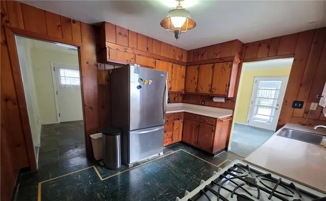 a kitchen with stainless steel appliances granite countertop a refrigerator and a stove