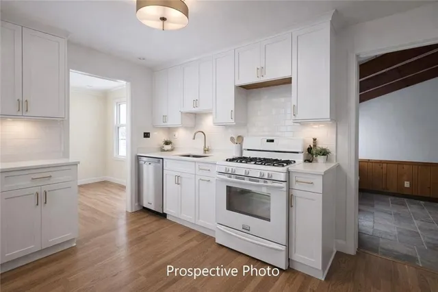 a kitchen with cabinets stainless steel appliances and a counter space
