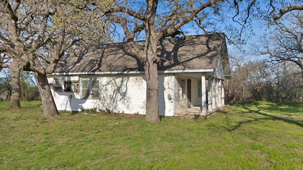202 Johns Road Chico, TX 76431 - Photo 4 of 33 a view of a yard with plants and large trees
