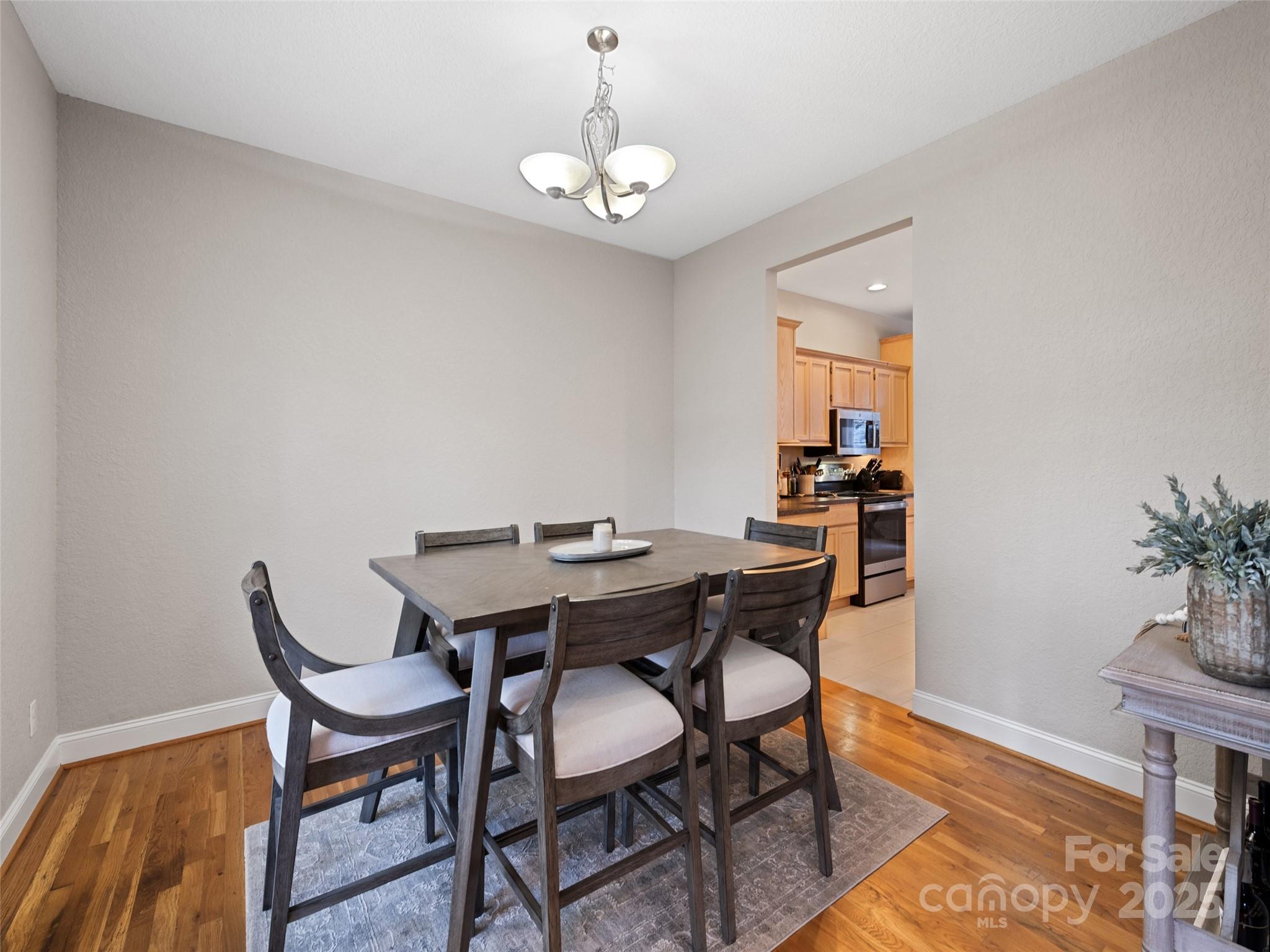 15 Lone Coyote Ridge Fletcher, NC 28732 - Photo 23 of 46 a view of a dining room with furniture and wooden floor
