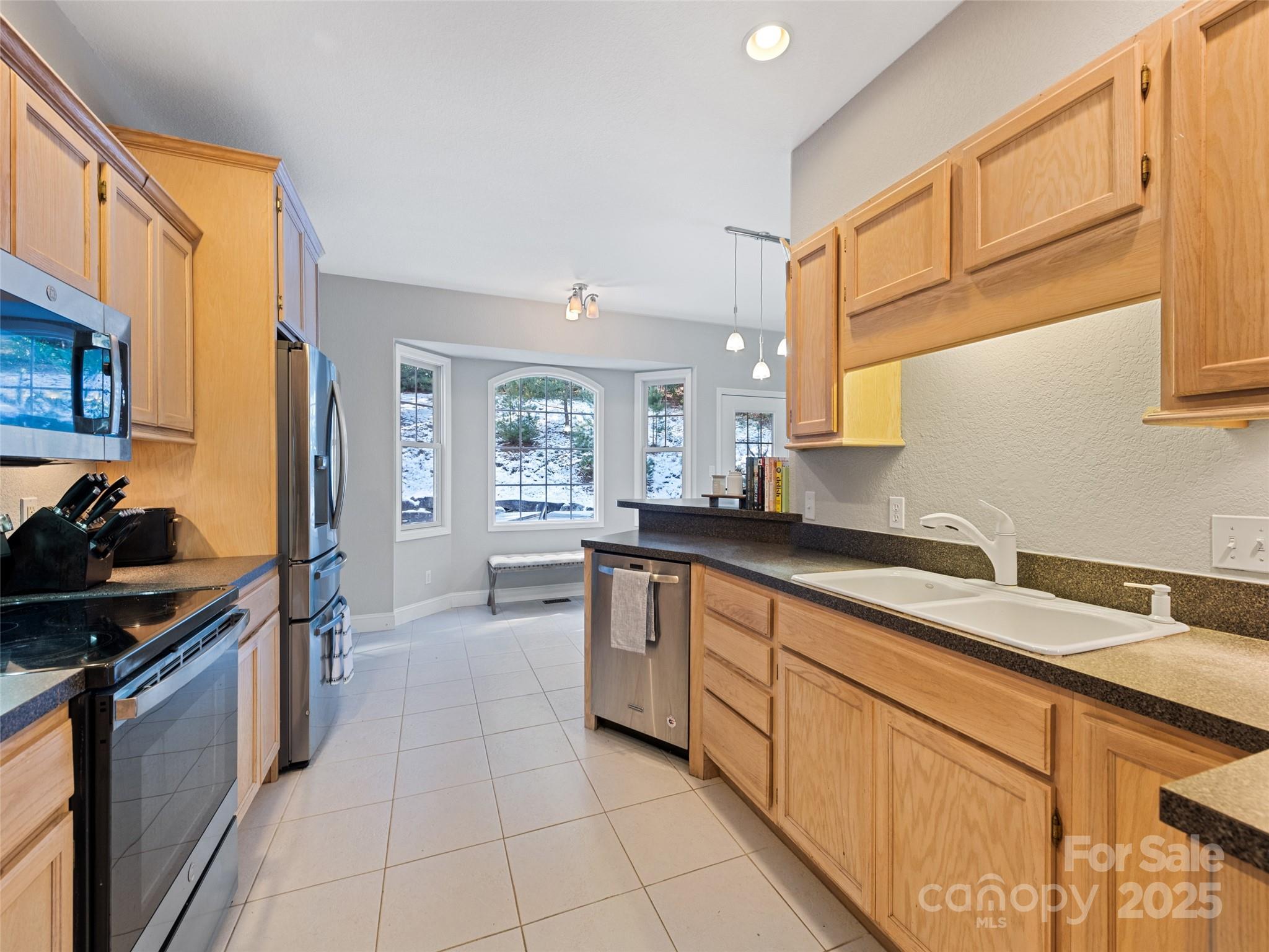15 Lone Coyote Ridge Fletcher, NC 28732 - Photo 24 of 46 a kitchen with stainless steel appliances granite countertop a sink and cabinets