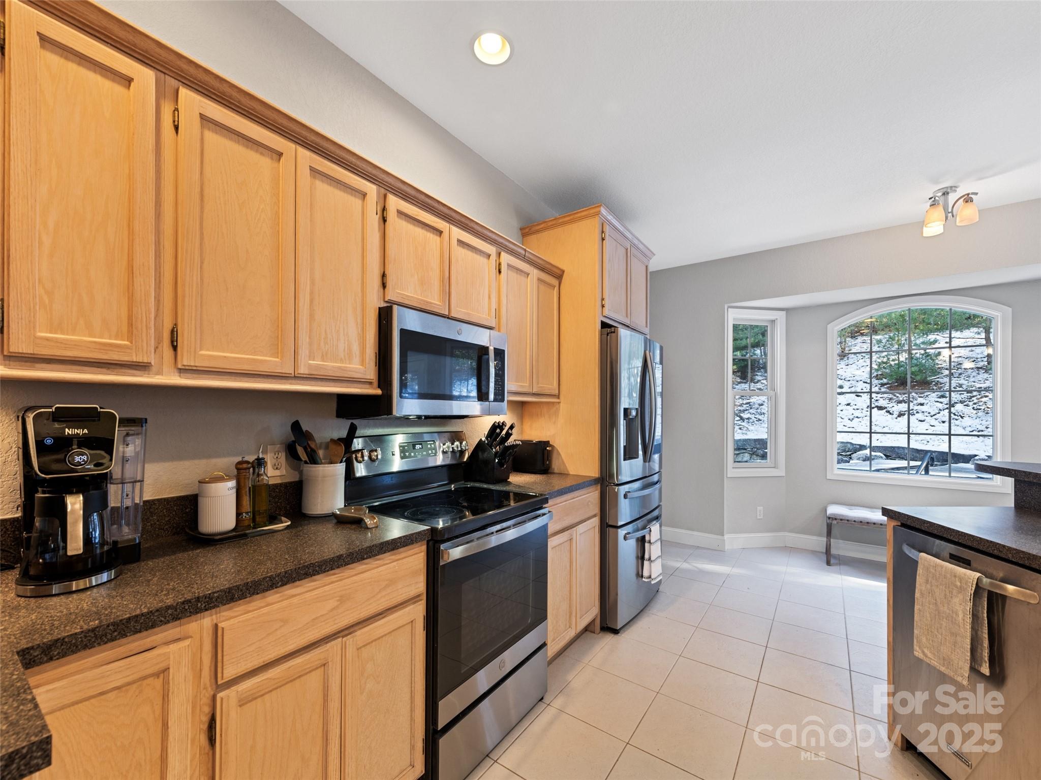 15 Lone Coyote Ridge Fletcher, NC 28732 - Photo 25 of 46 a kitchen with stainless steel appliances granite countertop a stove a sink and a white cabinets