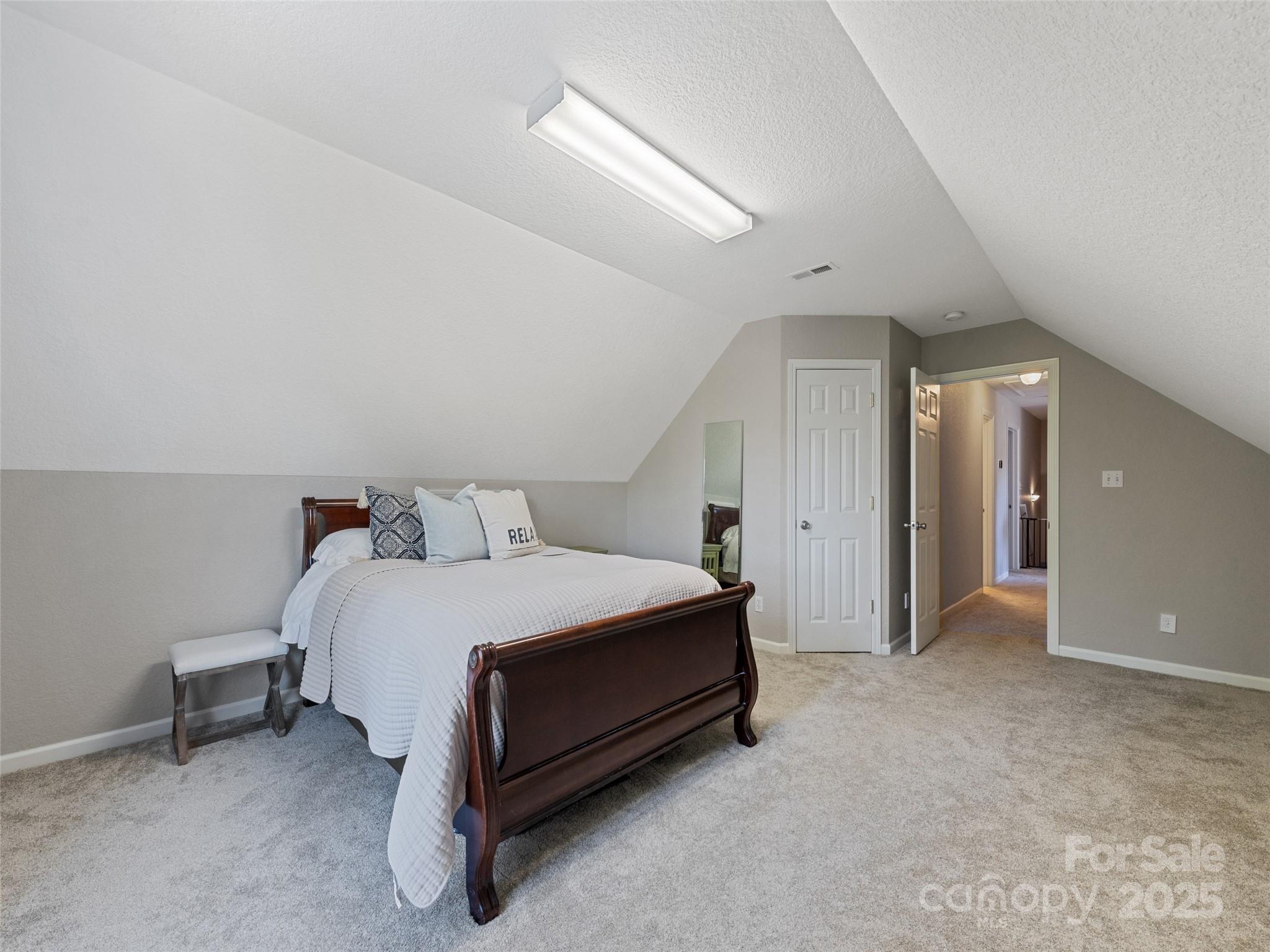 15 Lone Coyote Ridge Fletcher, NC 28732 - Photo 41 of 46 a spacious bedroom with a bed and a lamp on desk
