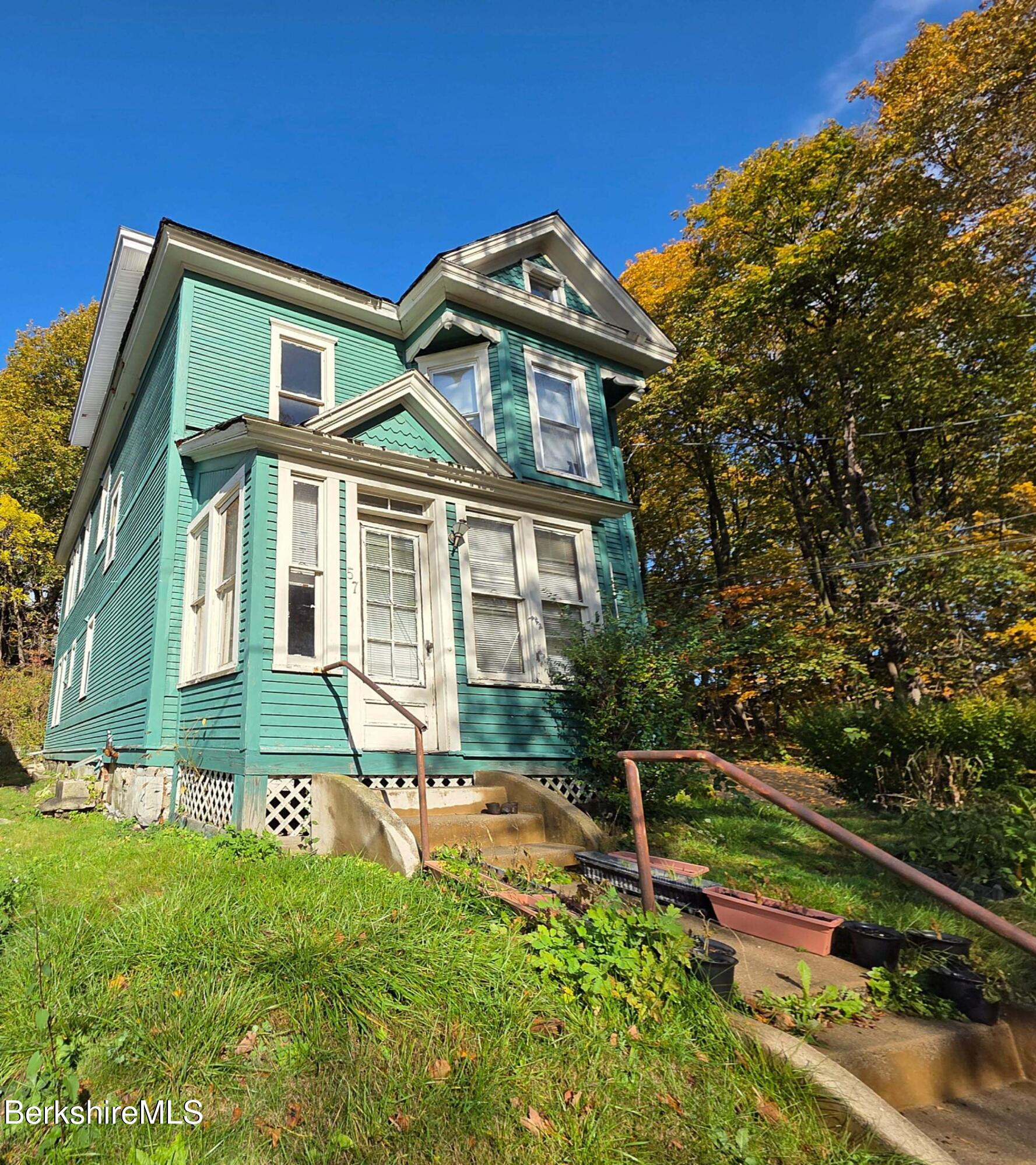 57 Beacon Street, Unit 3 North Adams, MA 01247 - Photo 1 of 10 a front view of a house with a yard