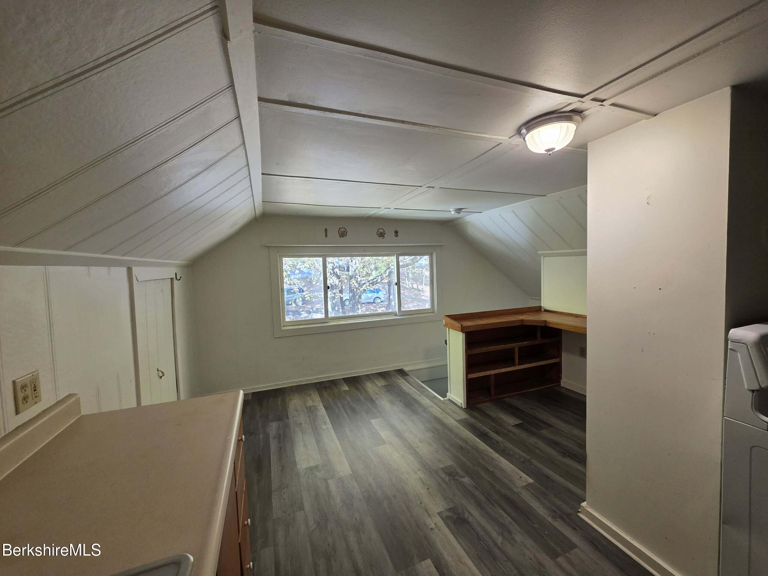 57 Beacon Street, Unit 3 North Adams, MA 01247 - Photo 6 of 10 a view of empty room with stairs and wooden floor