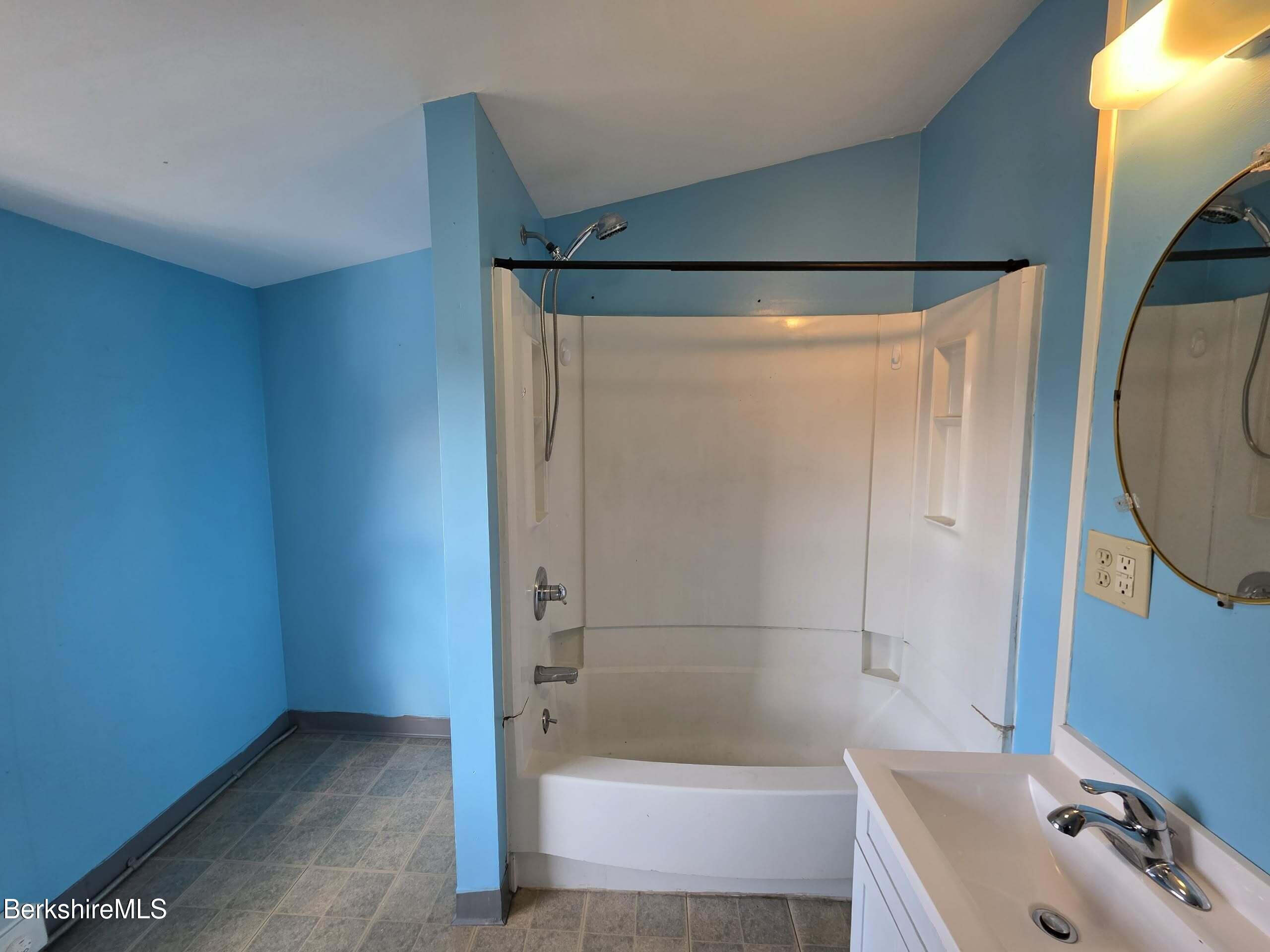 57 Beacon Street, Unit 3 North Adams, MA 01247 - Photo 9 of 10 a bathroom with a tub a mirror and a shower