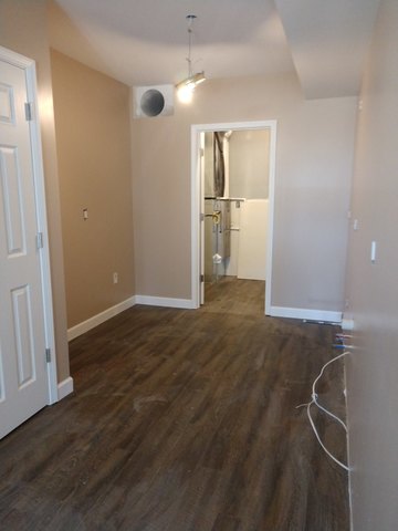 350 County Line Road Lee, IL 60530 - Photo 12 of 31 an empty room with wooden floor and a bathroom
