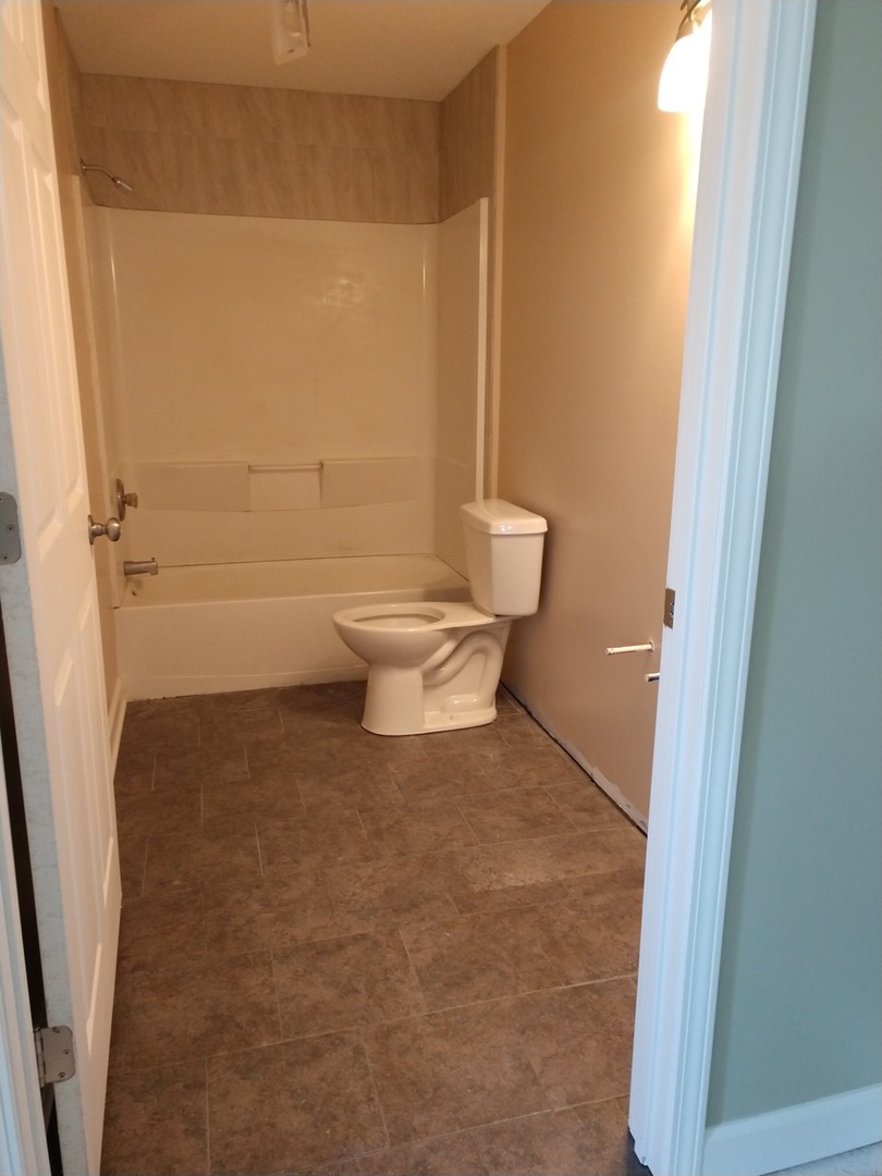 350 County Line Road Lee, IL 60530 - Photo 20 of 31 a bathroom with a toilet and a shower