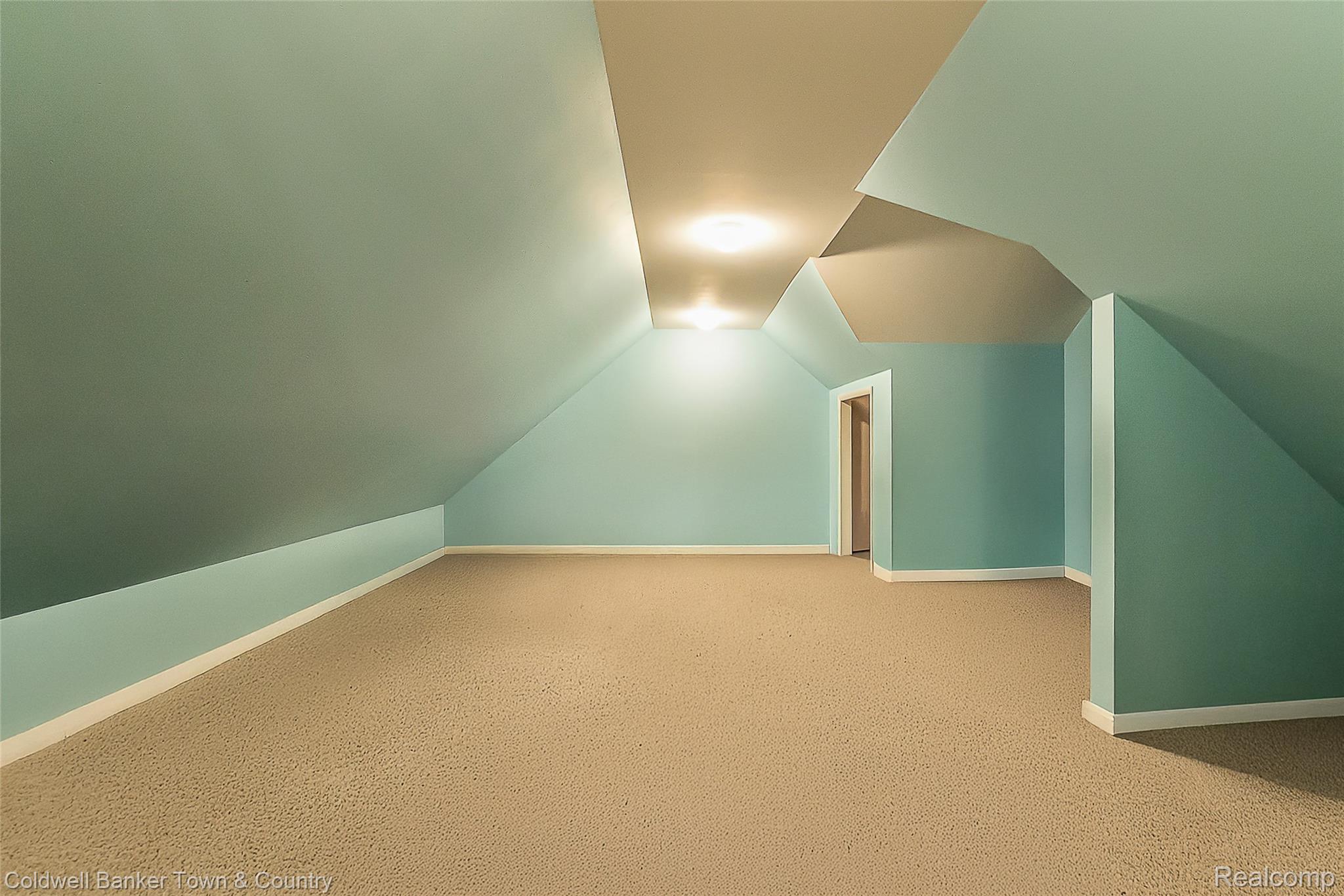 11527 Mcgregor Road Pinckney, MI 48169 - Photo 18 of 26 Additional living space featuring carpet flooring and lofted ceiling