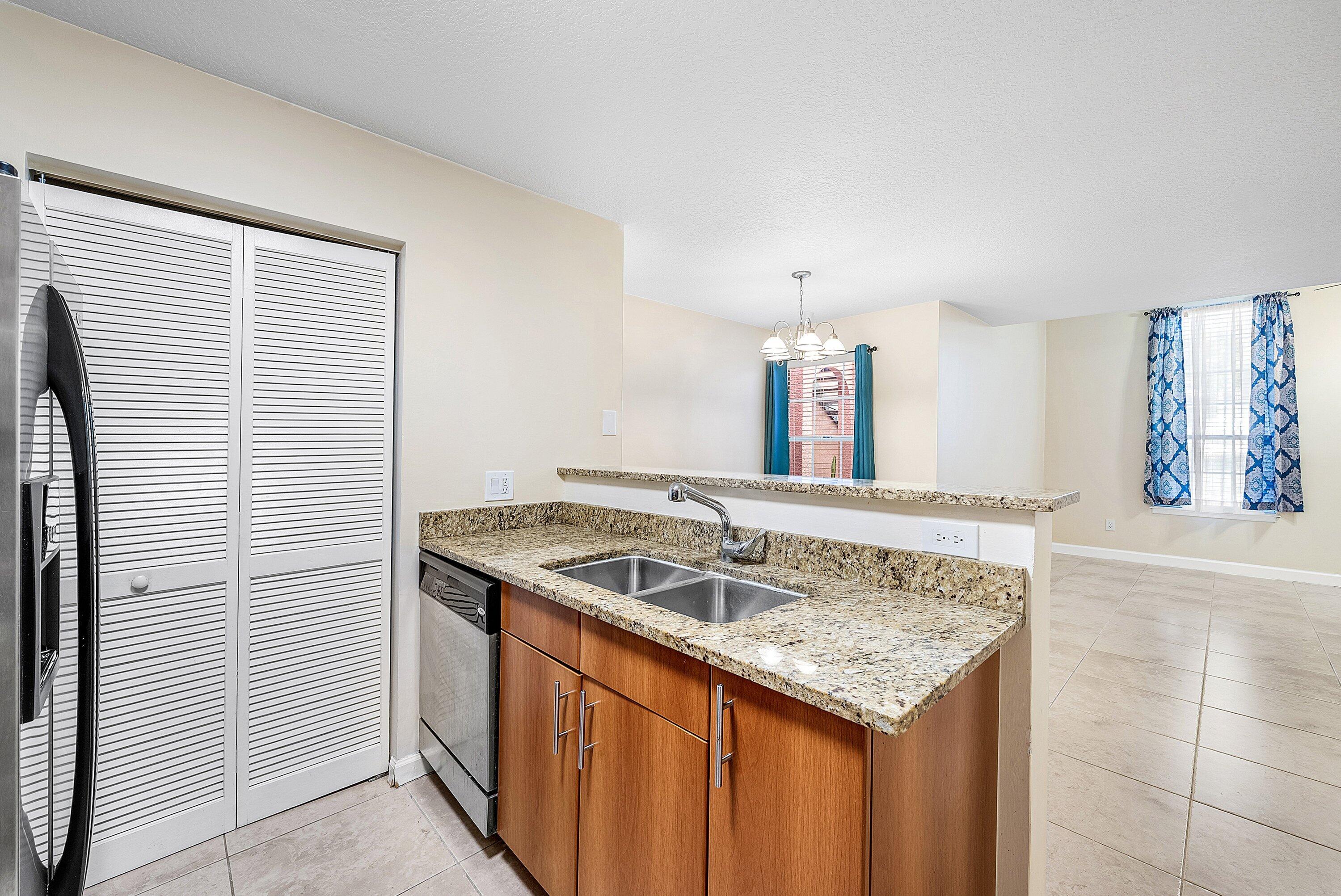 1001 Crystal Way, Unit M Delray Beach, FL 33444 - Photo 13 of 42 a kitchen with a sink and cabinets