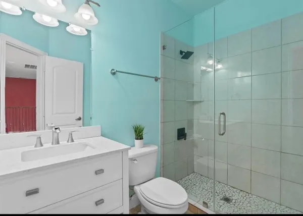 a bathroom with a sink vanity and mirror