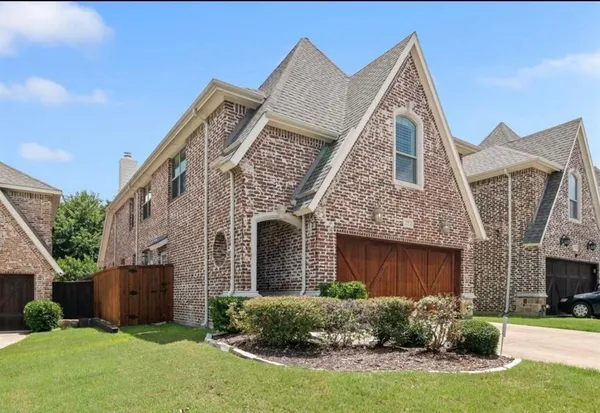 a view of a livingroom with a fireplace wooden floor and windows
