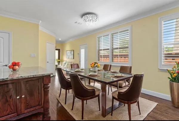 a spacious bedroom with a bed and a chandelier