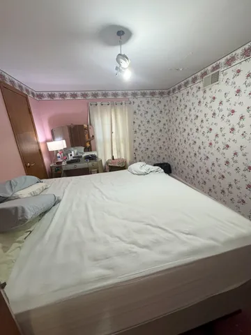 a view of a hallway with furniture and wooden floor