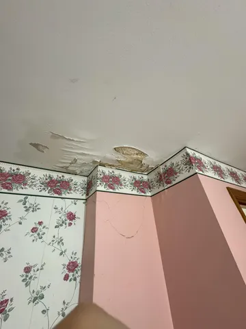a view of empty room with wooden floor and closet
